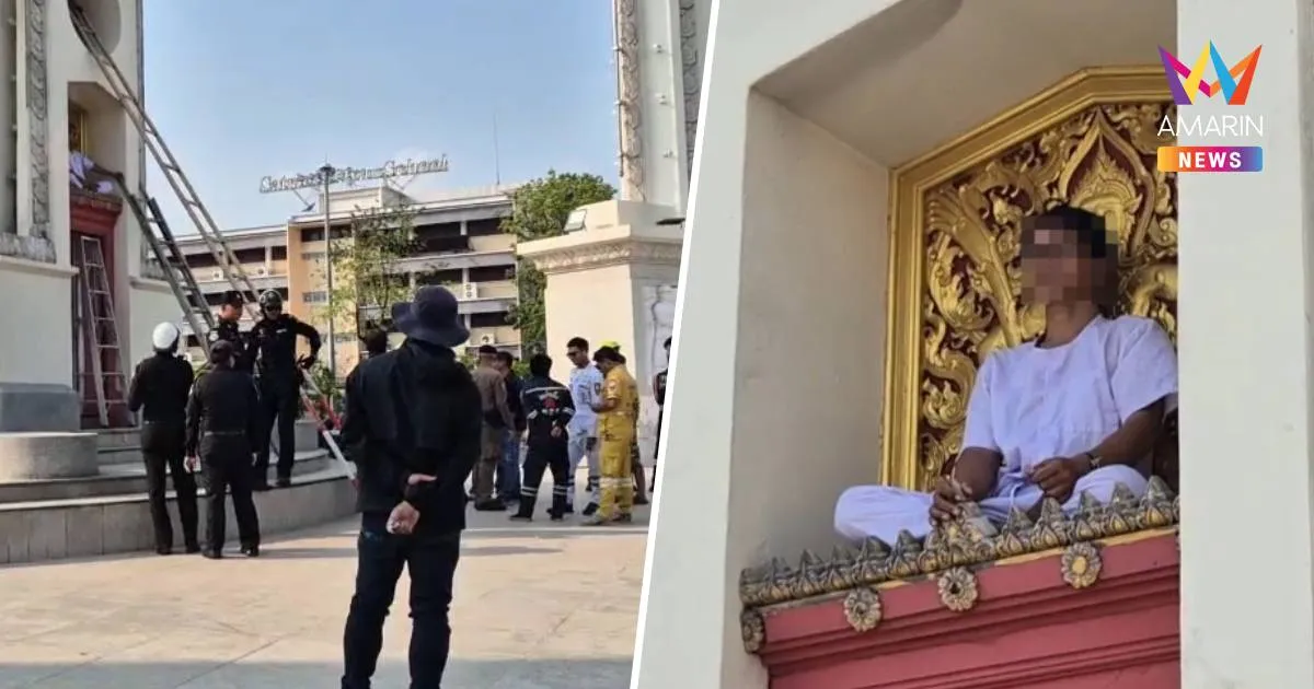 ชายปีนขึ้นไปนั่งบนอนุสาวรีย์ชัยสมรภูมิ